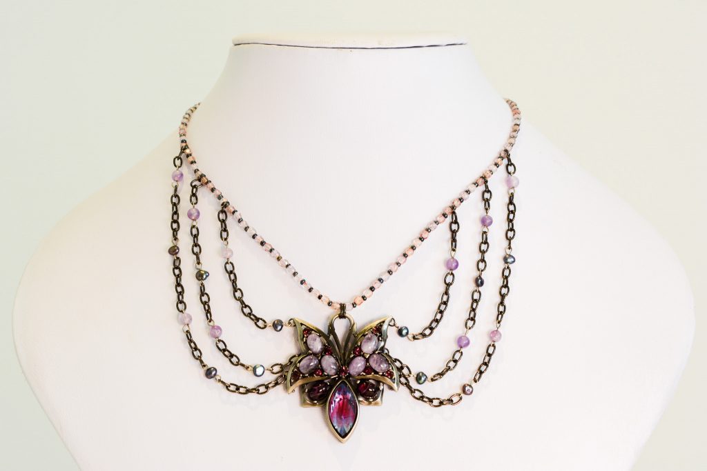 A swag necklace with a butterfly